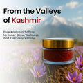 Jar of Kashmiri saffron with saffron flowers and mountains in the background